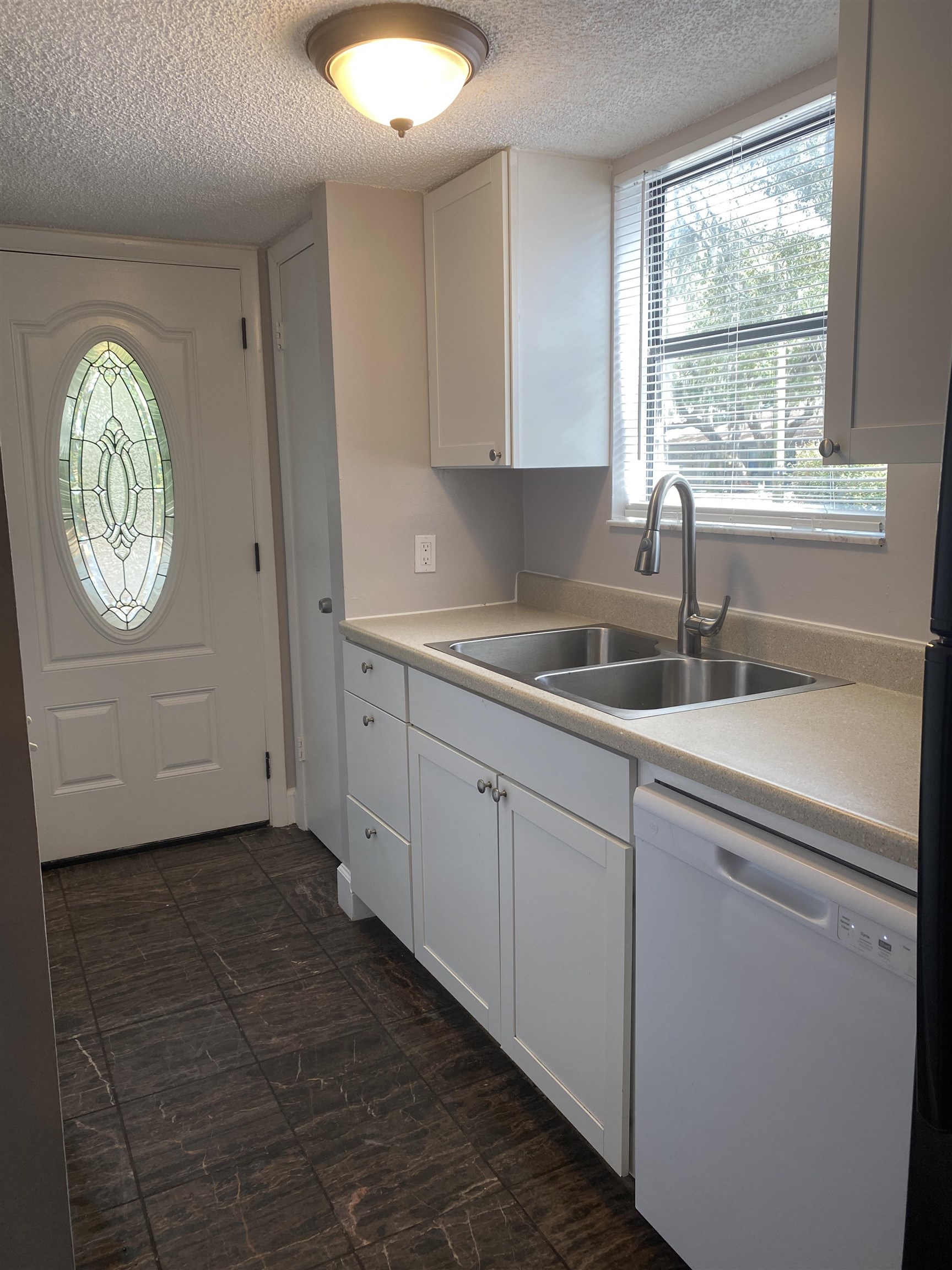 35 Atlantic Oaks Circle, Unit A St. Augustine Beach, FL 32080 - Photo 3 of 21 a kitchen with a sink cabinets and window