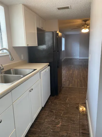 a kitchen with a sink and refrigerator