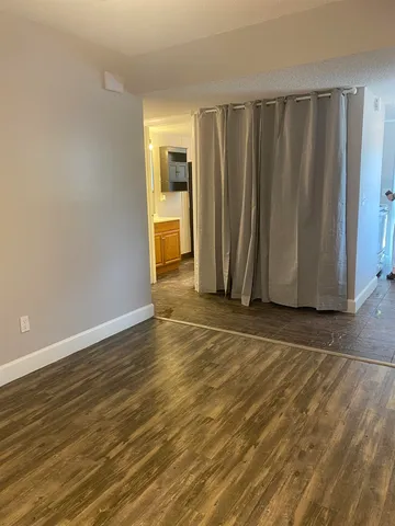 a view of a room with wooden floor