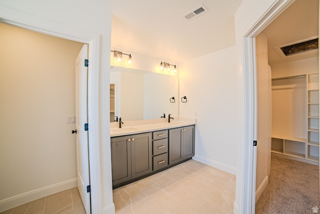 45 North Scarlet Maple Road, Unit 4317 Vineyard, UT 84059 - Photo 17 of 35 Contemporary bathroom featuring a double vanity with gray cabinetry, light-colored countertops, and matte black fixtures