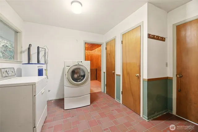 a utility room with sink dryer and washer