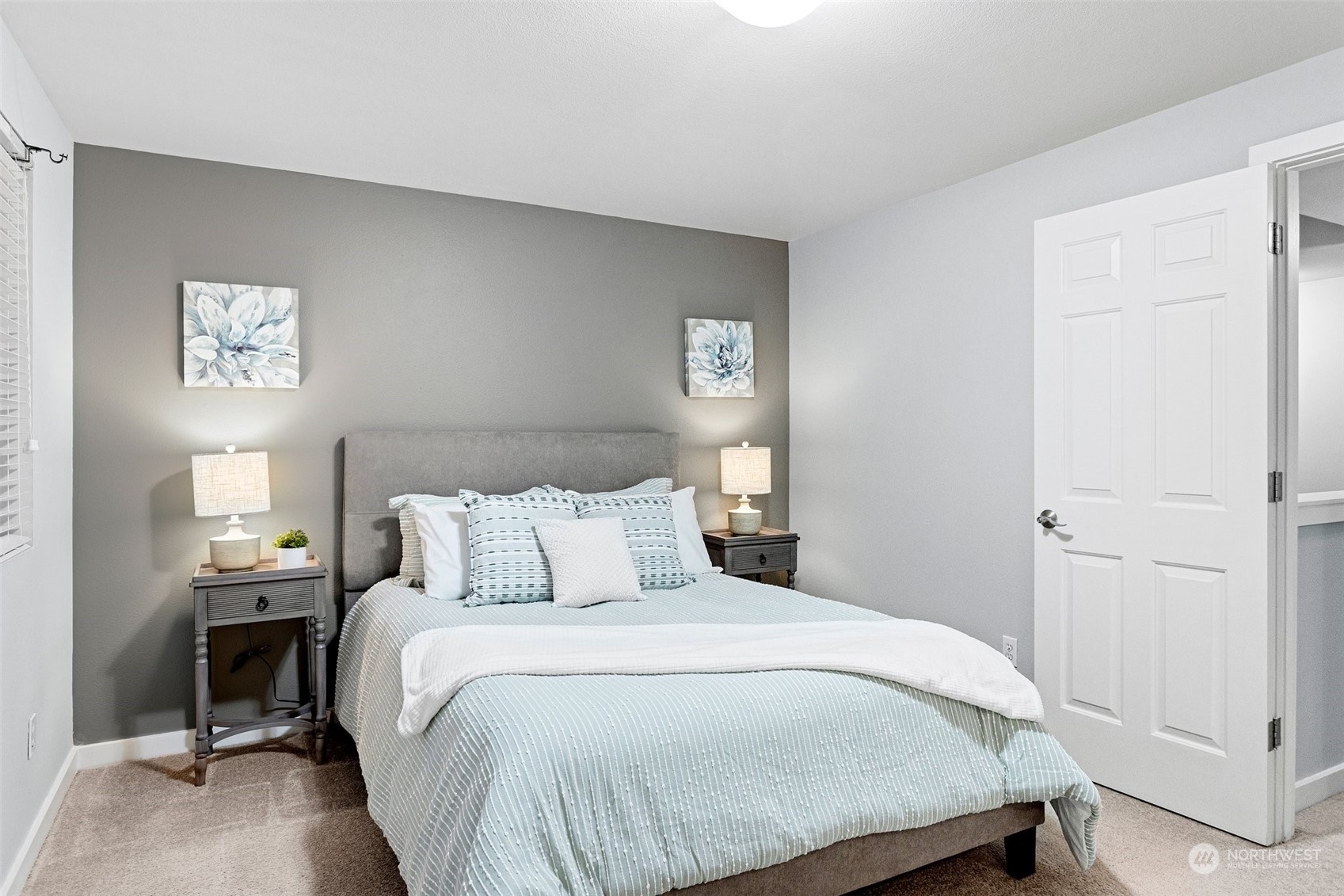 18930 Bothell Everett Highway, Unit L102 Bothell, WA 98012 - Photo 20 of 28 a bedroom with a bed and a night stand