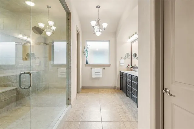 a bathroom with a granite countertop sink a toilet a mirror and shower