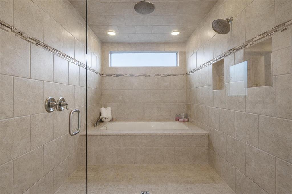 437 Middleton Drive Roanoke, TX 76262 - Photo 21 of 40 Serene primary bath with a walk- in shower and integrated soaking tub, surrounded by calming neutral tile for a true spa-like experience.