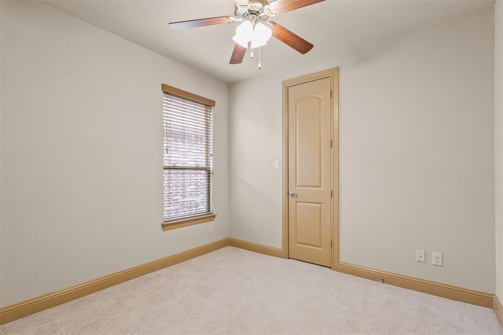 437 Middleton Drive Roanoke, TX 76262 - Photo 27 of 40 First- level bedroom with a spacious walk-in closet
