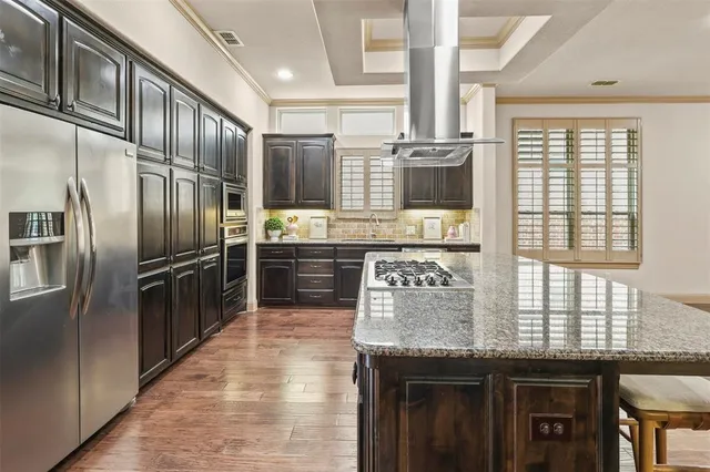a kitchen with cabinets and chairs