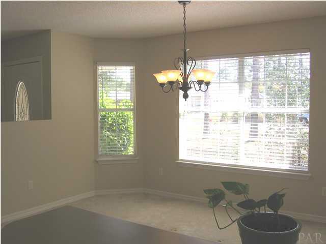 7346 Treasure Street Navarre, FL 32566 - Photo 3 of 14 Looking from Kitchen into the beautiful & bright dining room.