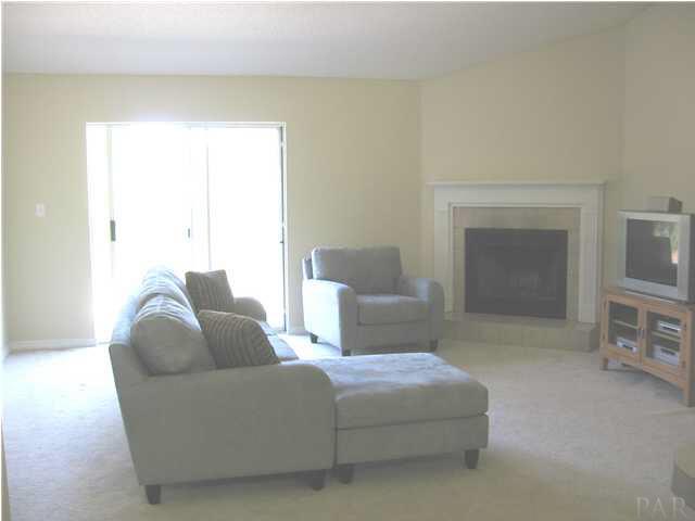 7346 Treasure Street Navarre, FL 32566 - Photo 4 of 14 Huge Great Room w/fireplace. Sliding glass doors lead to the patio and back yard.