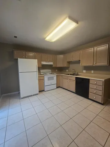 a kitchen with cabinets and oven