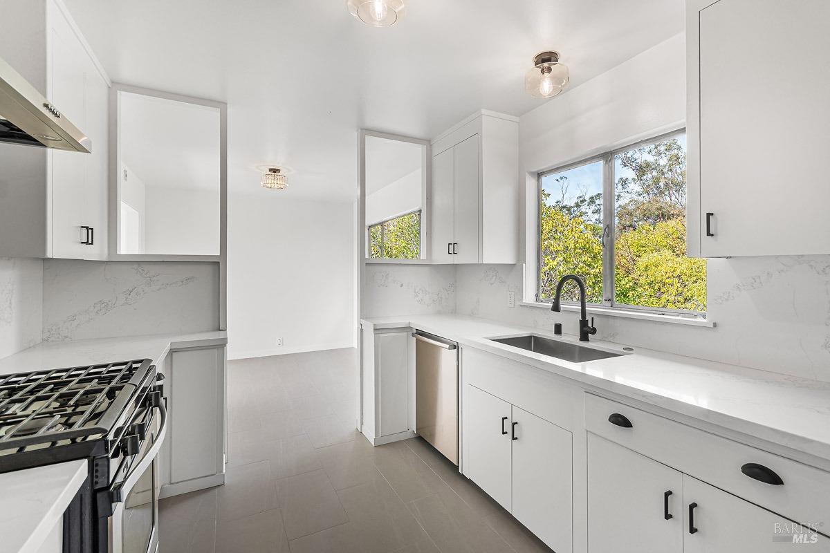 9 Alta Vista Way San Rafael, CA 94901 - Photo 1 of 1 a kitchen with stainless steel appliances granite countertop a sink a stove and a window