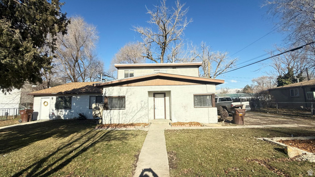 265 Rigdon Avenue, Unit 1 Salt Lake City, UT 84115 - Photo 2 of 15 Split-level residence featuring a brown shingle roof and a concrete walkway