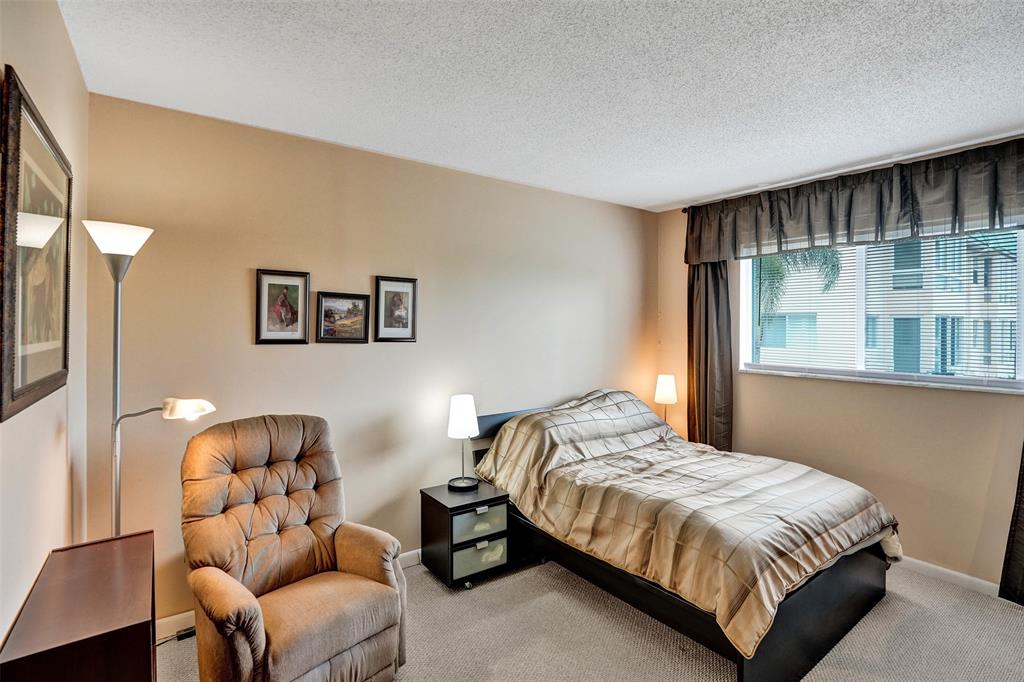 32 Colonial Club Drive, Unit 202 Boynton Beach, FL 33435 - Photo 15 of 38 a bedroom with a bed and couch