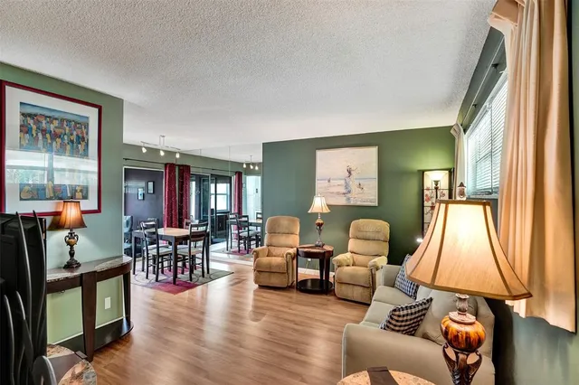 a view of game room with wooden floor and furniture