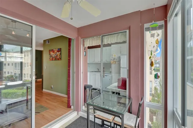 a view of a hallway with wooden floor and entryway