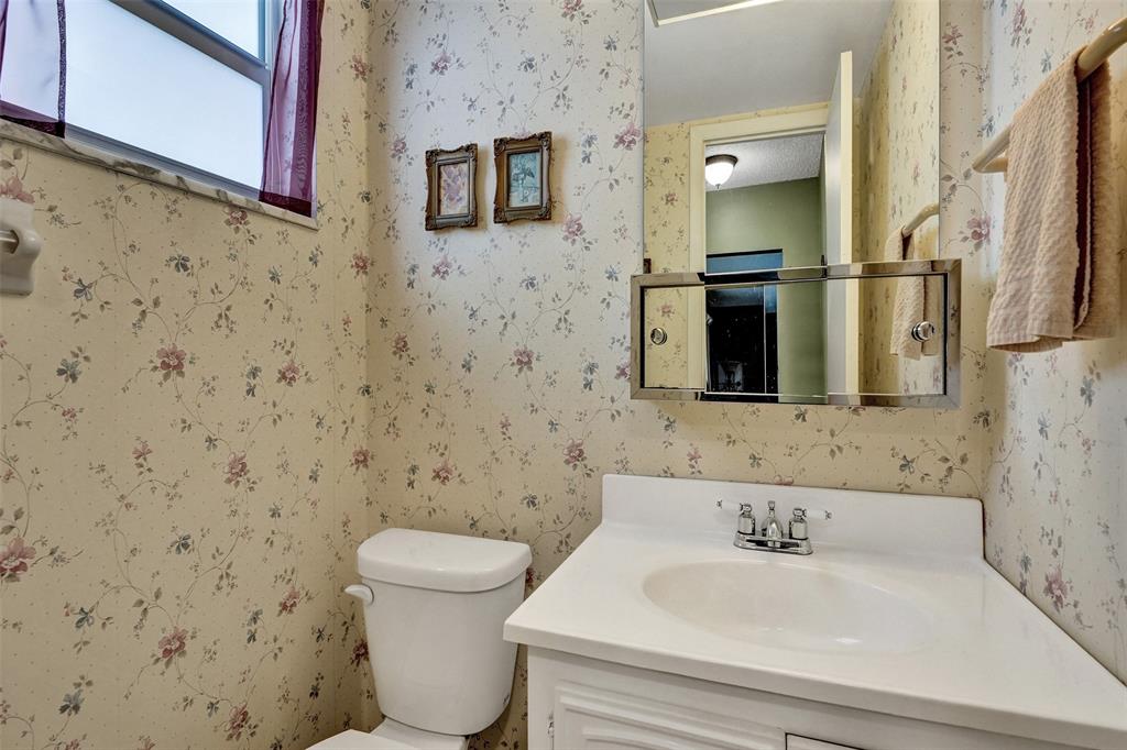 32 Colonial Club Drive, Unit 202 Boynton Beach, FL 33435 - Photo 23 of 38 a bathroom with a sink and a mirror