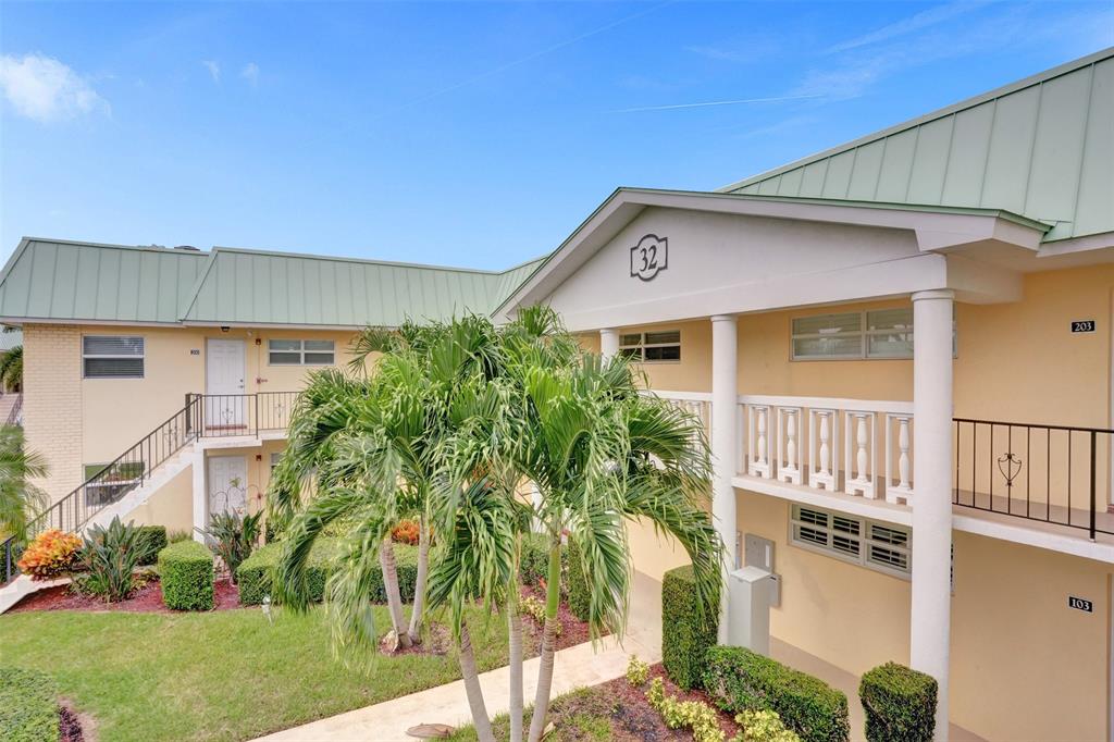 32 Colonial Club Drive, Unit 202 Boynton Beach, FL 33435 - Photo 29 of 38 a front view of a house with garden