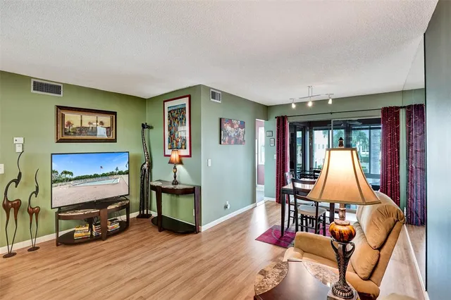 a bedroom with furniture and a wooden floor