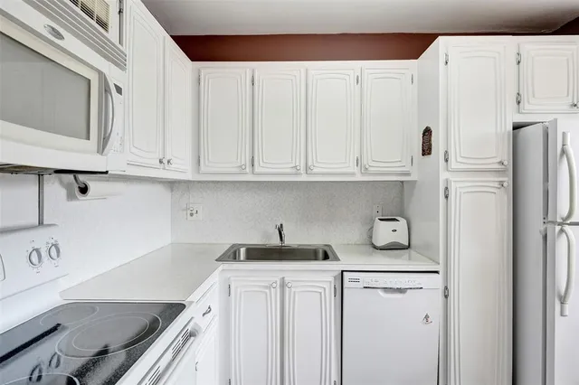 a kitchen with stainless steel appliances granite countertop a refrigerator sink and cabinets