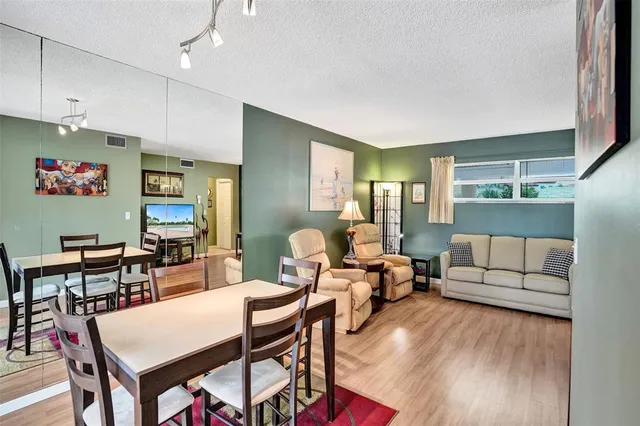 a kitchen with white cabinets and sink