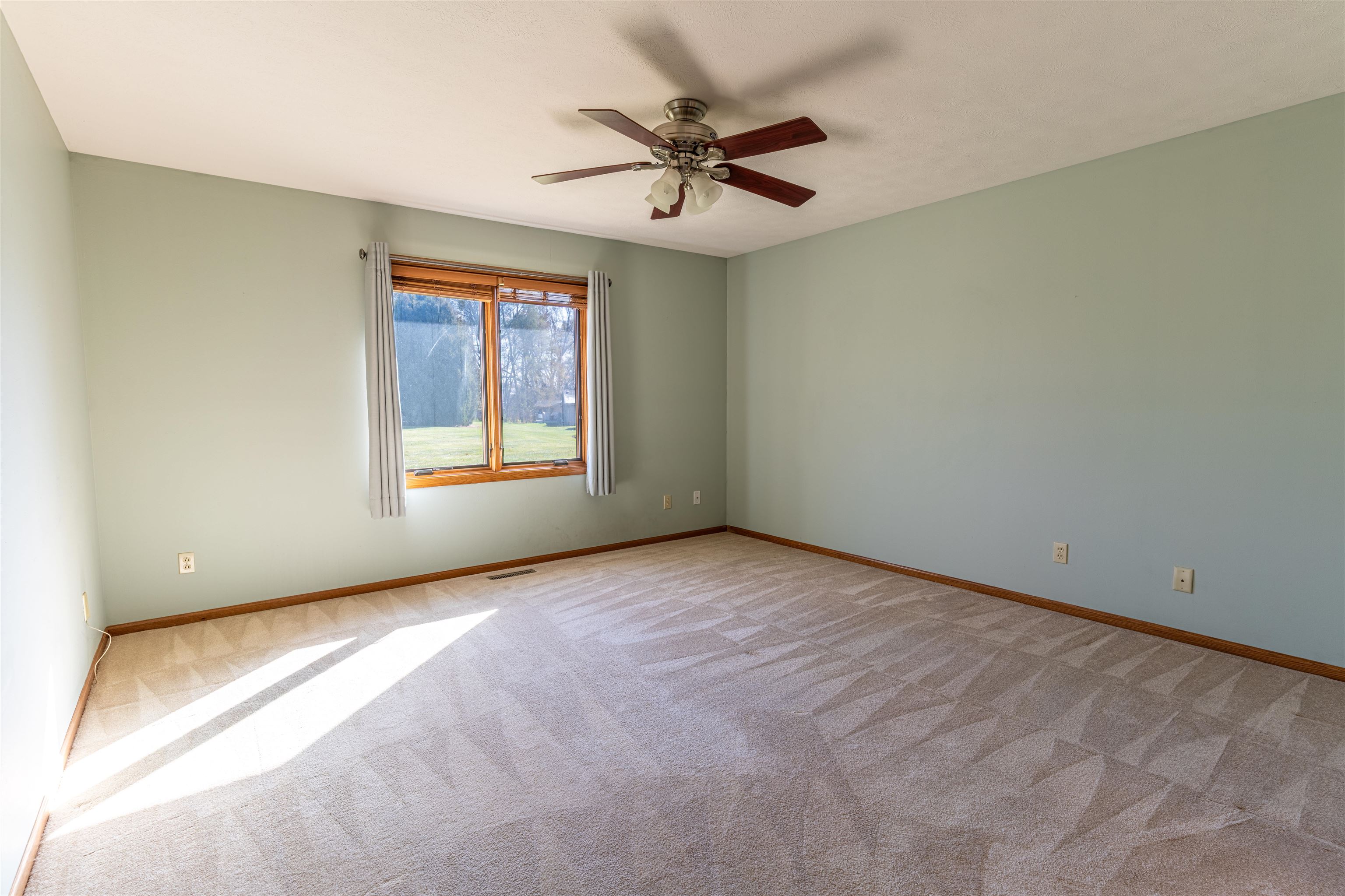 5269 Windsor Road Loves Park, IL 61111 - Photo 17 of 32 a view of a livingroom with a ceiling fan and window