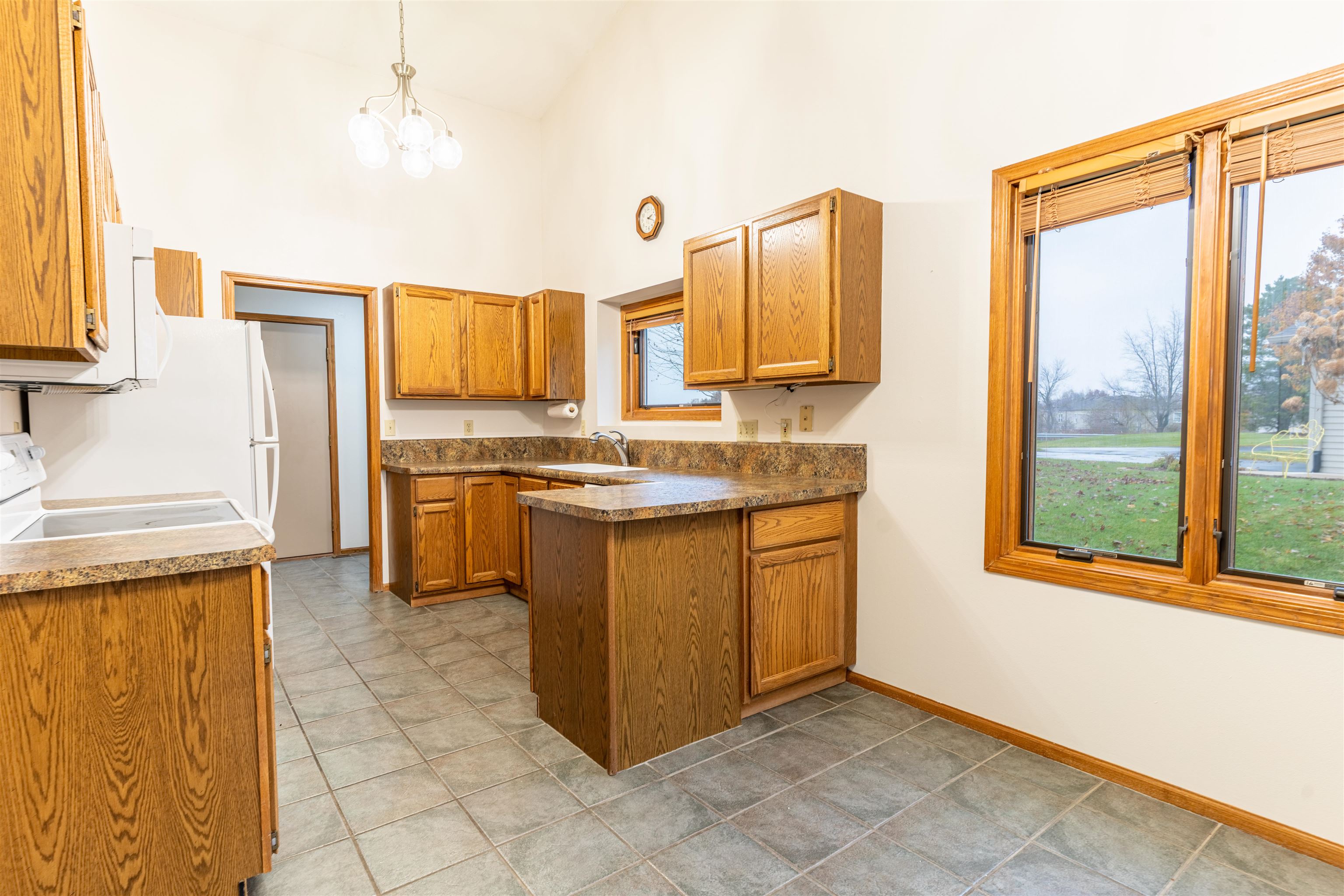 5269 Windsor Road Loves Park, IL 61111 - Photo 18 of 32 a kitchen with stainless steel appliances granite countertop a stove a sink and a refrigerator