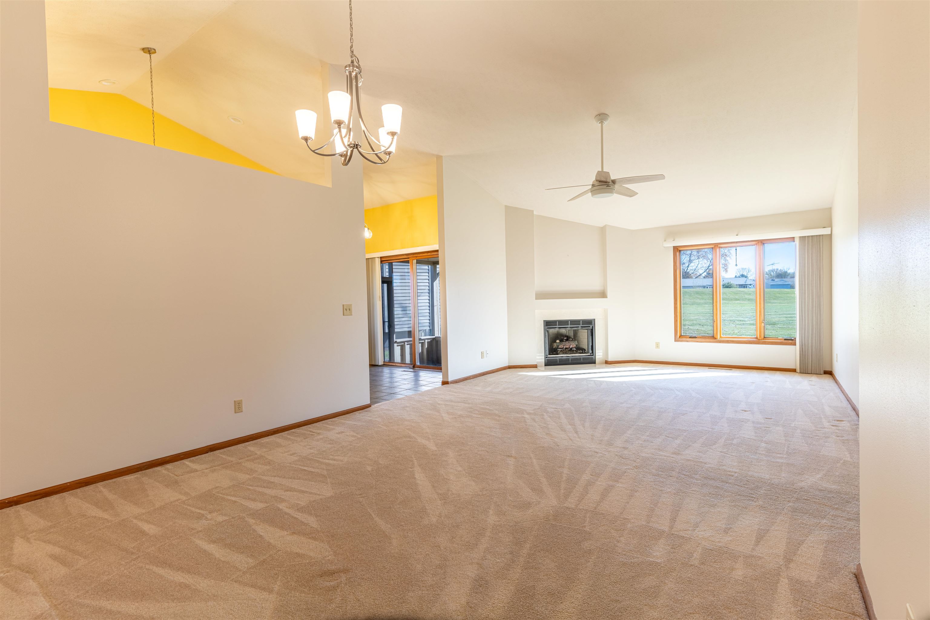 5269 Windsor Road Loves Park, IL 61111 - Photo 4 of 32 a furnished livingroom with windows and chandelier fan