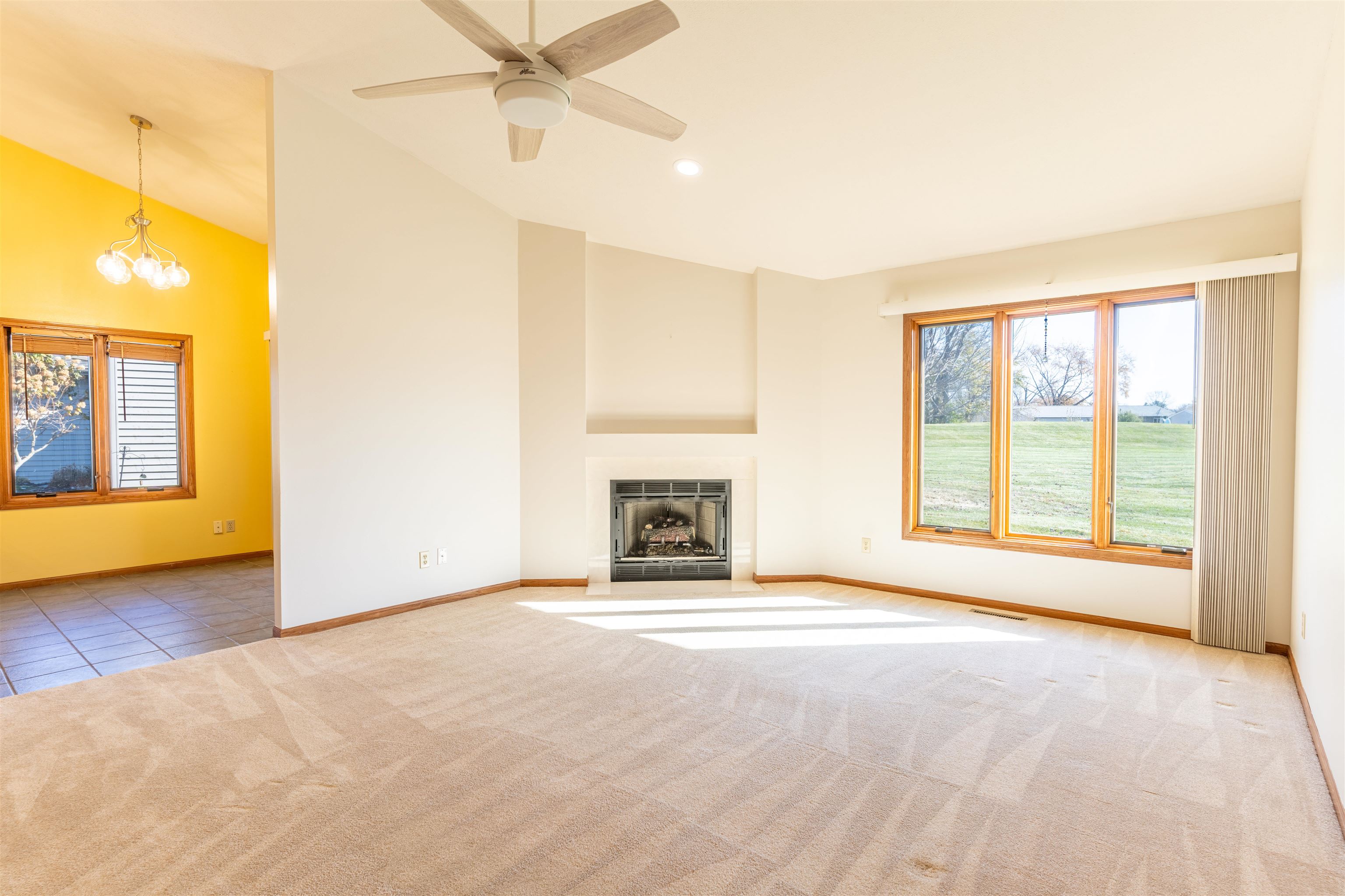 5269 Windsor Road Loves Park, IL 61111 - Photo 6 of 32 a view of an empty room with a fireplace and a window