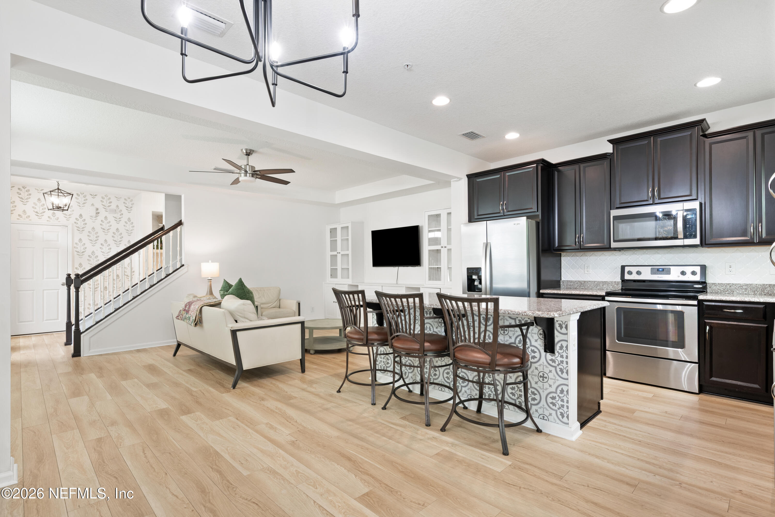 111 Paradas Place St. Augustine, FL 32092 - Photo 13 of 46 a living room with stainless steel appliances furniture and a wooden floor