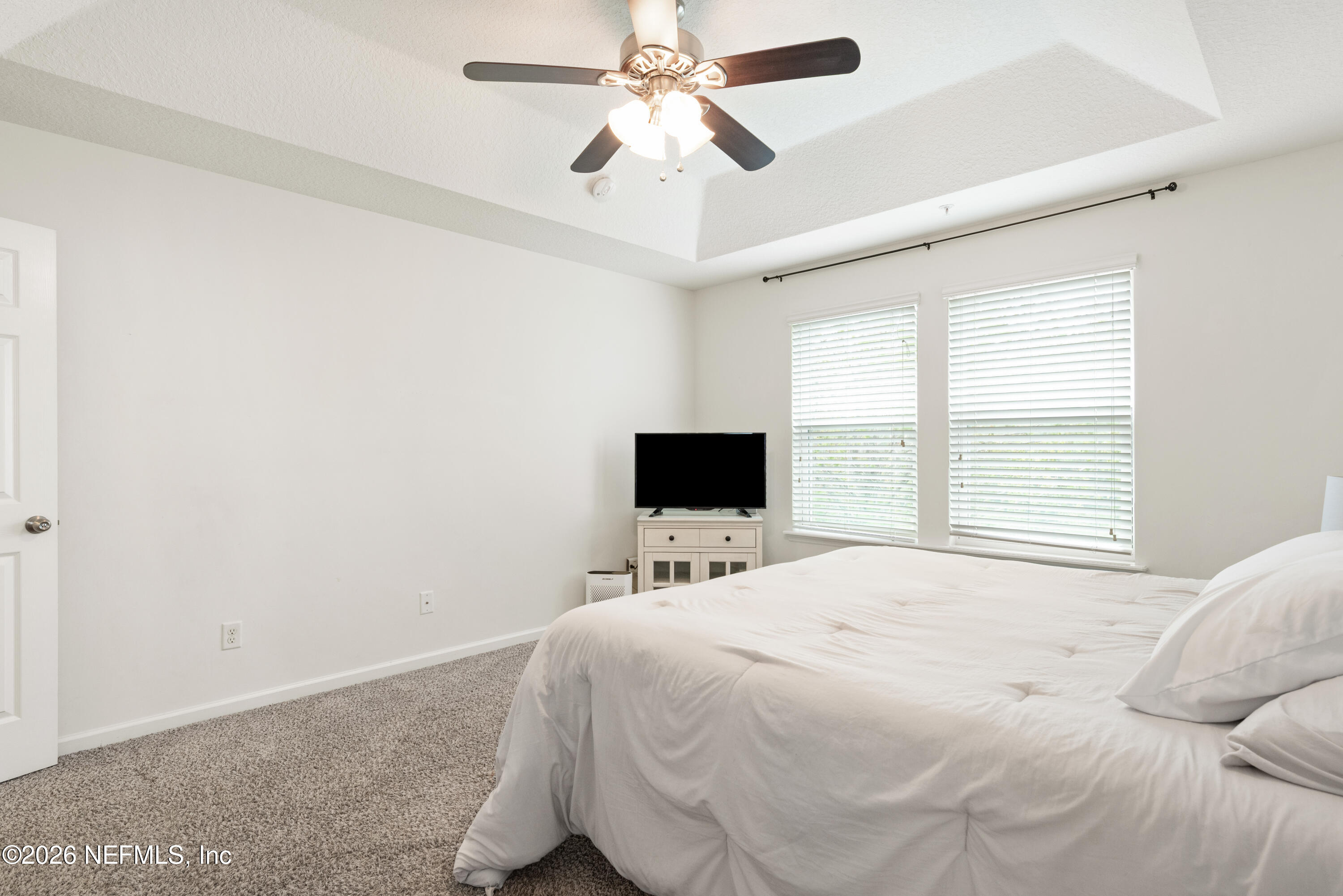 111 Paradas Place St. Augustine, FL 32092 - Photo 25 of 46 a bedroom with a bed and a flat tv screen on the dresser
