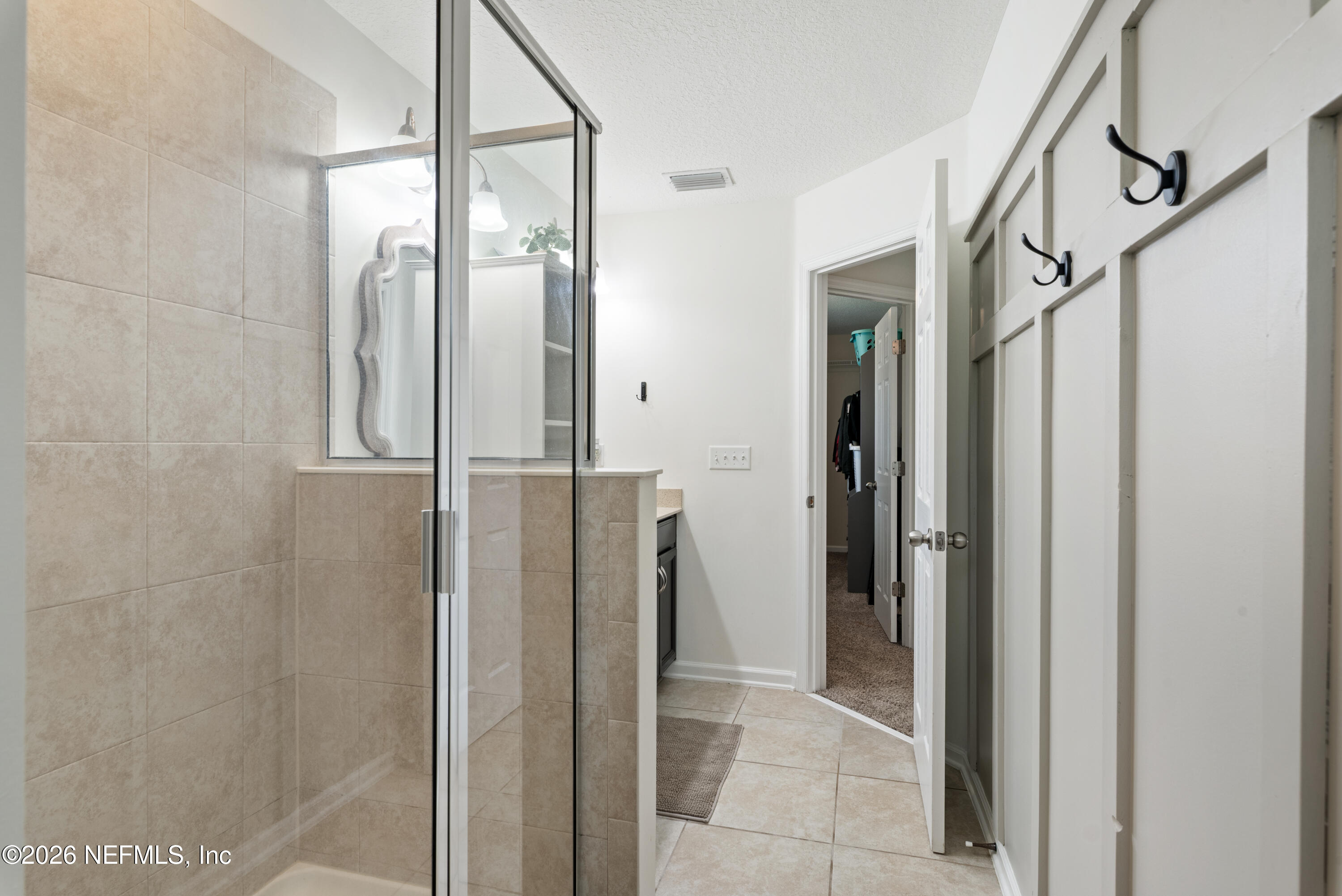 111 Paradas Place St. Augustine, FL 32092 - Photo 27 of 46 a bathroom with a glass shower door and a glass door