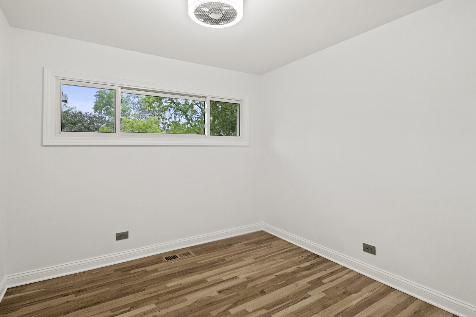 580 Geronimo Street Hoffman Estates, IL 60169 - Photo 13 of 28 a view of an empty room with wooden floor and a window