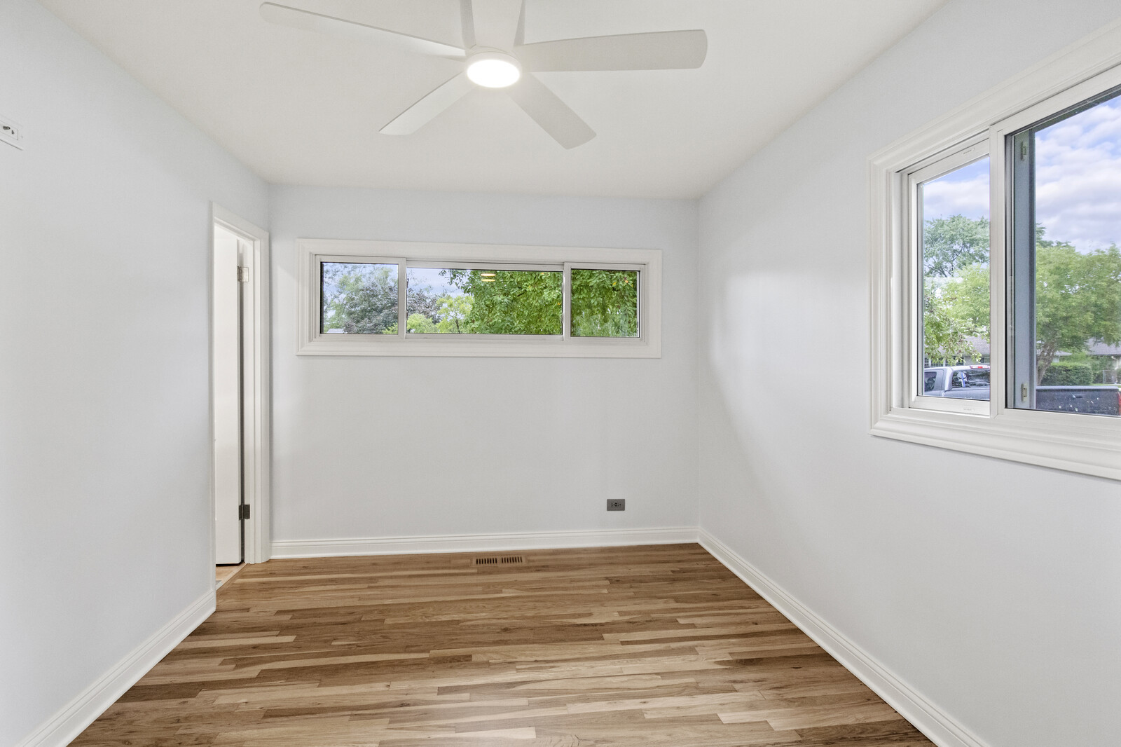 580 Geronimo Street Hoffman Estates, IL 60169 - Photo 19 of 28 wooden floor in an empty room with a window
