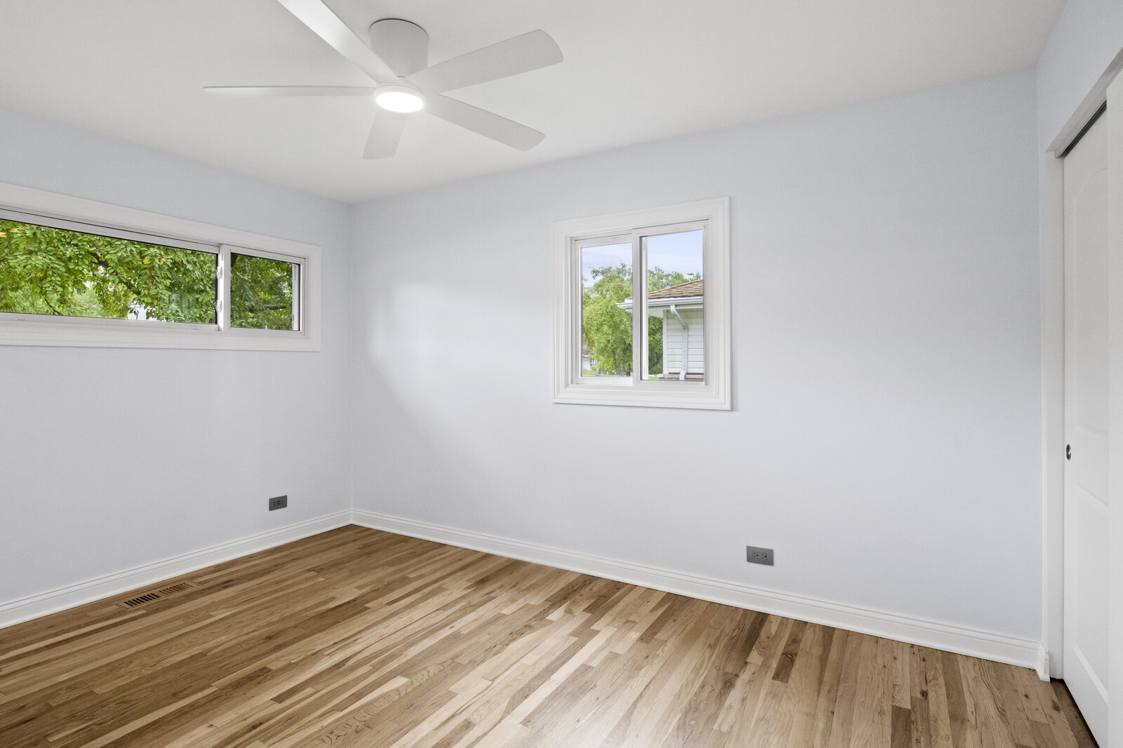 580 Geronimo Street Hoffman Estates, IL 60169 - Photo 21 of 28 a view of empty room with wooden floor and fan