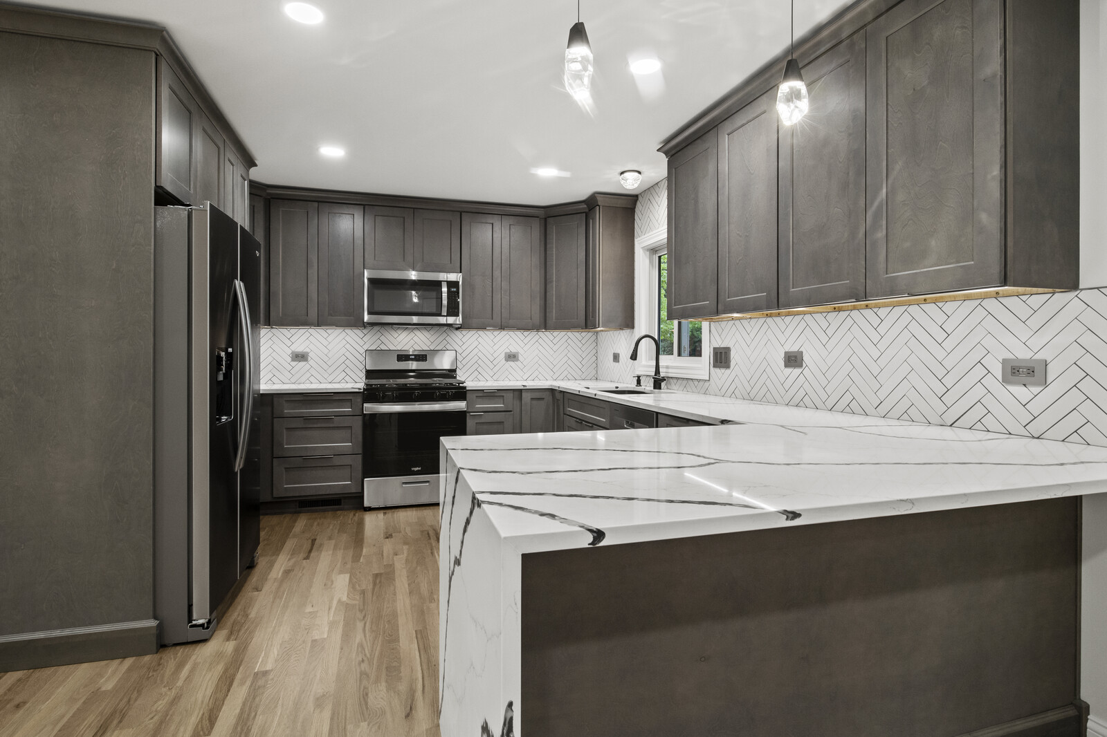 580 Geronimo Street Hoffman Estates, IL 60169 - Photo 4 of 28 a kitchen with kitchen island white cabinets and stainless steel appliances