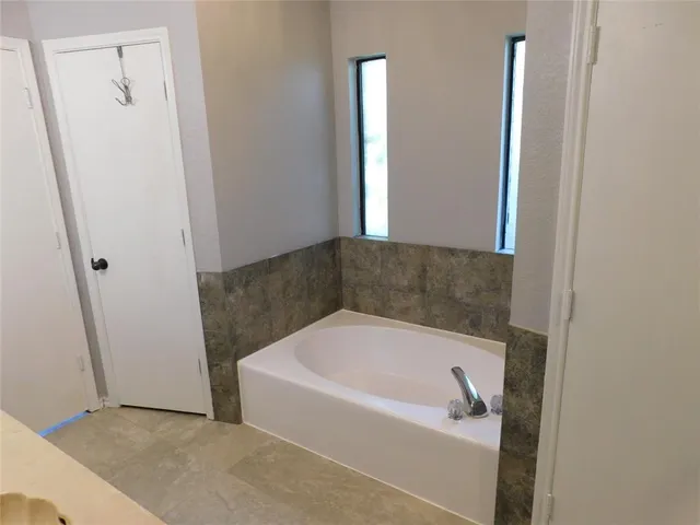 a bathroom with bathtub and shower