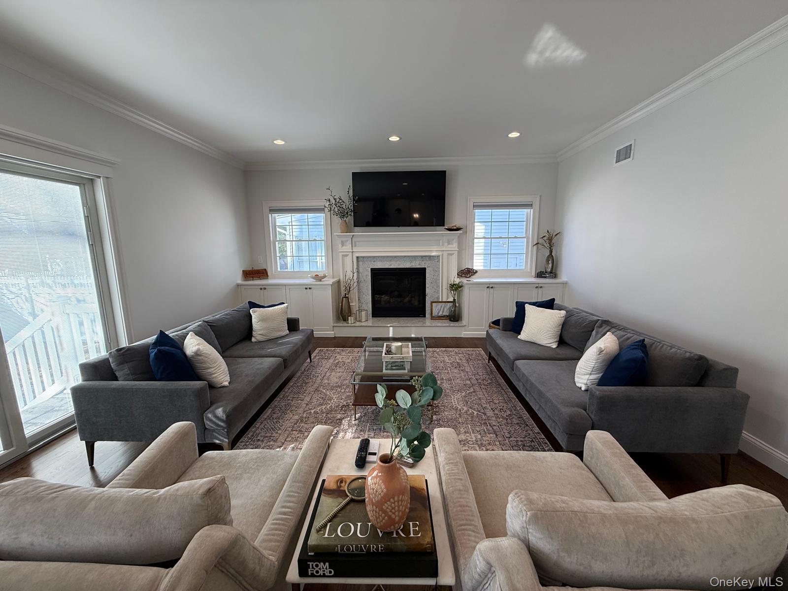116 Winifred Drive Merrick, NY 11566 - Photo 11 of 40 a living room with furniture fireplace and a flat screen tv