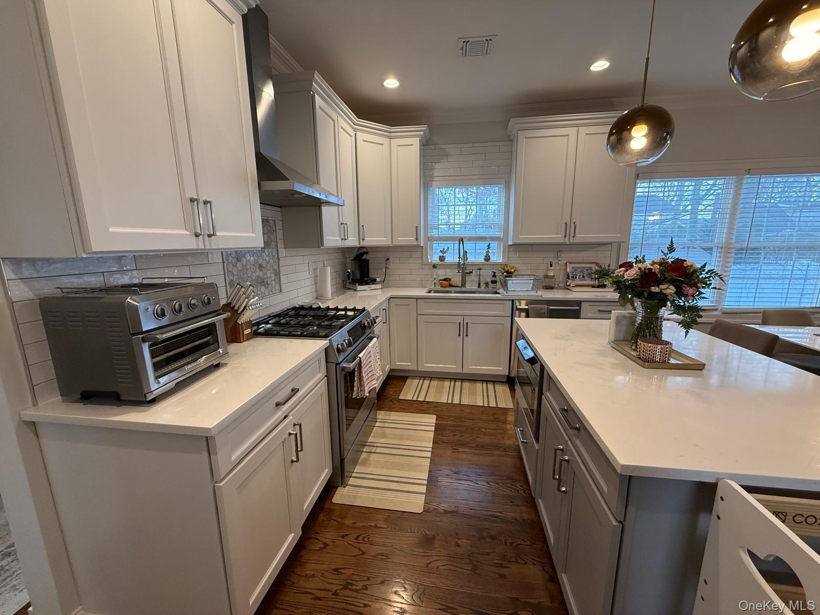 116 Winifred Drive Merrick, NY 11566 - Photo 13 of 40 a kitchen with a sink a stove and cabinets