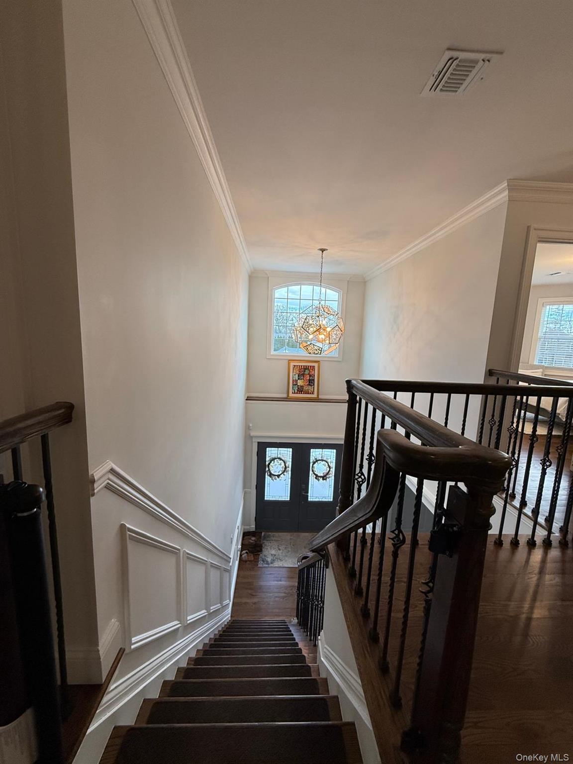 116 Winifred Drive Merrick, NY 11566 - Photo 17 of 40 a view of a hallway with wooden floor and staircase
