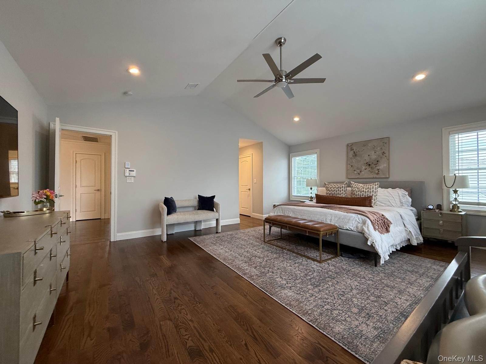 116 Winifred Drive Merrick, NY 11566 - Photo 20 of 40 a spacious bedroom with a bed and a chandelier