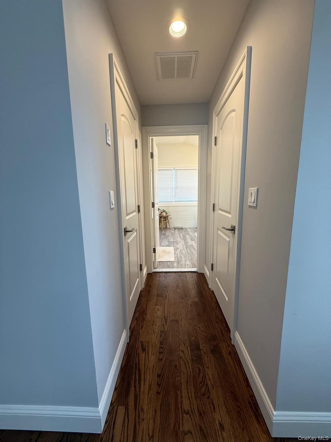 116 Winifred Drive Merrick, NY 11566 - Photo 21 of 40 a view of a hallway with wooden floor and a fireplace