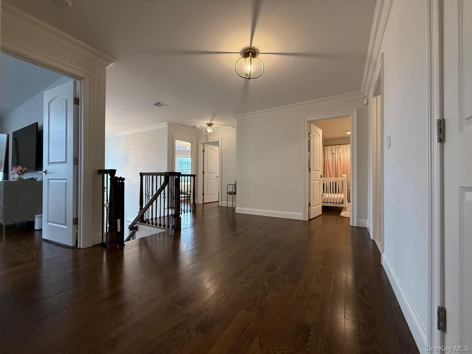 116 Winifred Drive Merrick, NY 11566 - Photo 27 of 40 a view of a hallway with wooden floor a fireplace