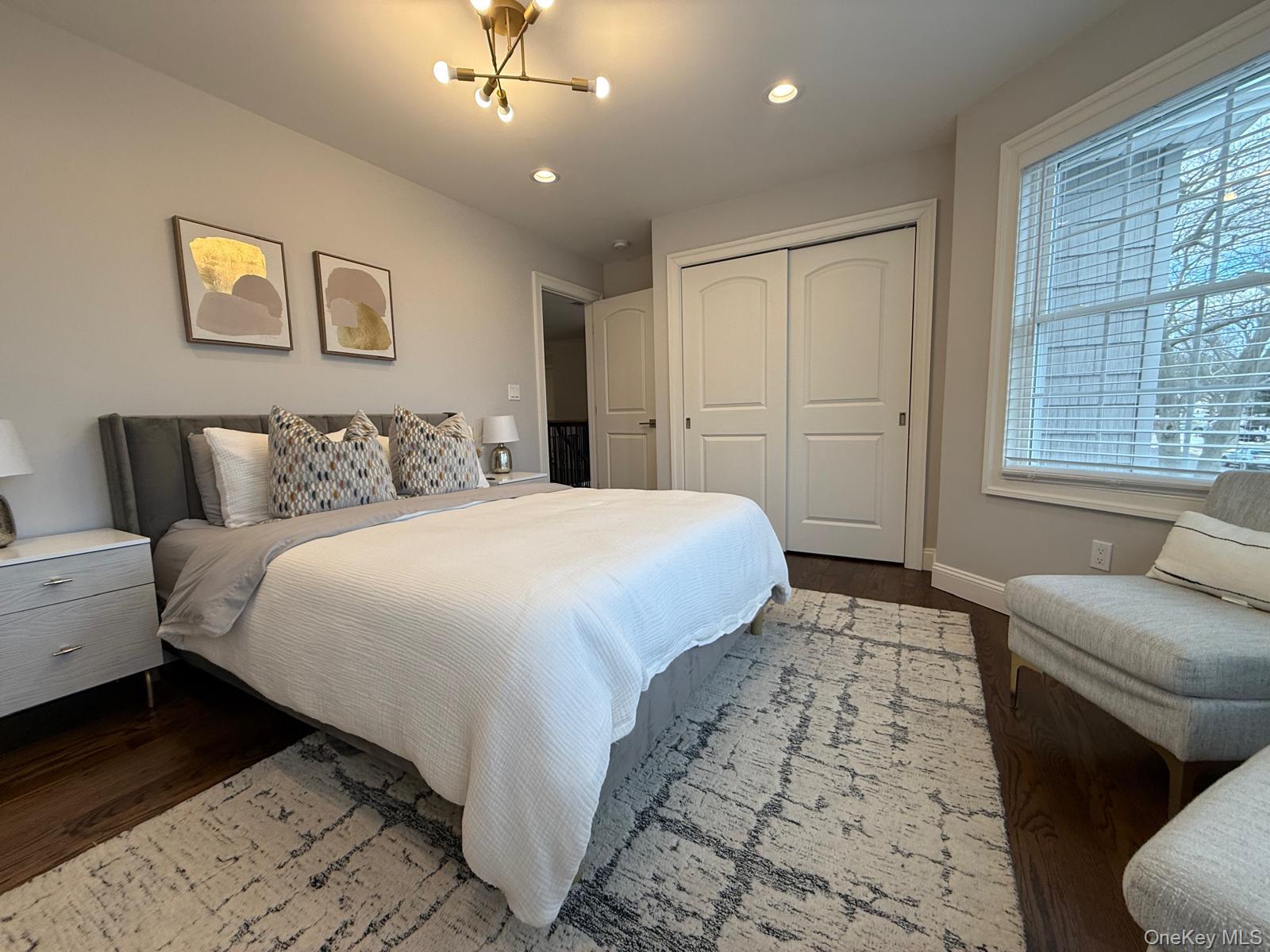 116 Winifred Drive Merrick, NY 11566 - Photo 28 of 40 a bedroom with a bed and a couch