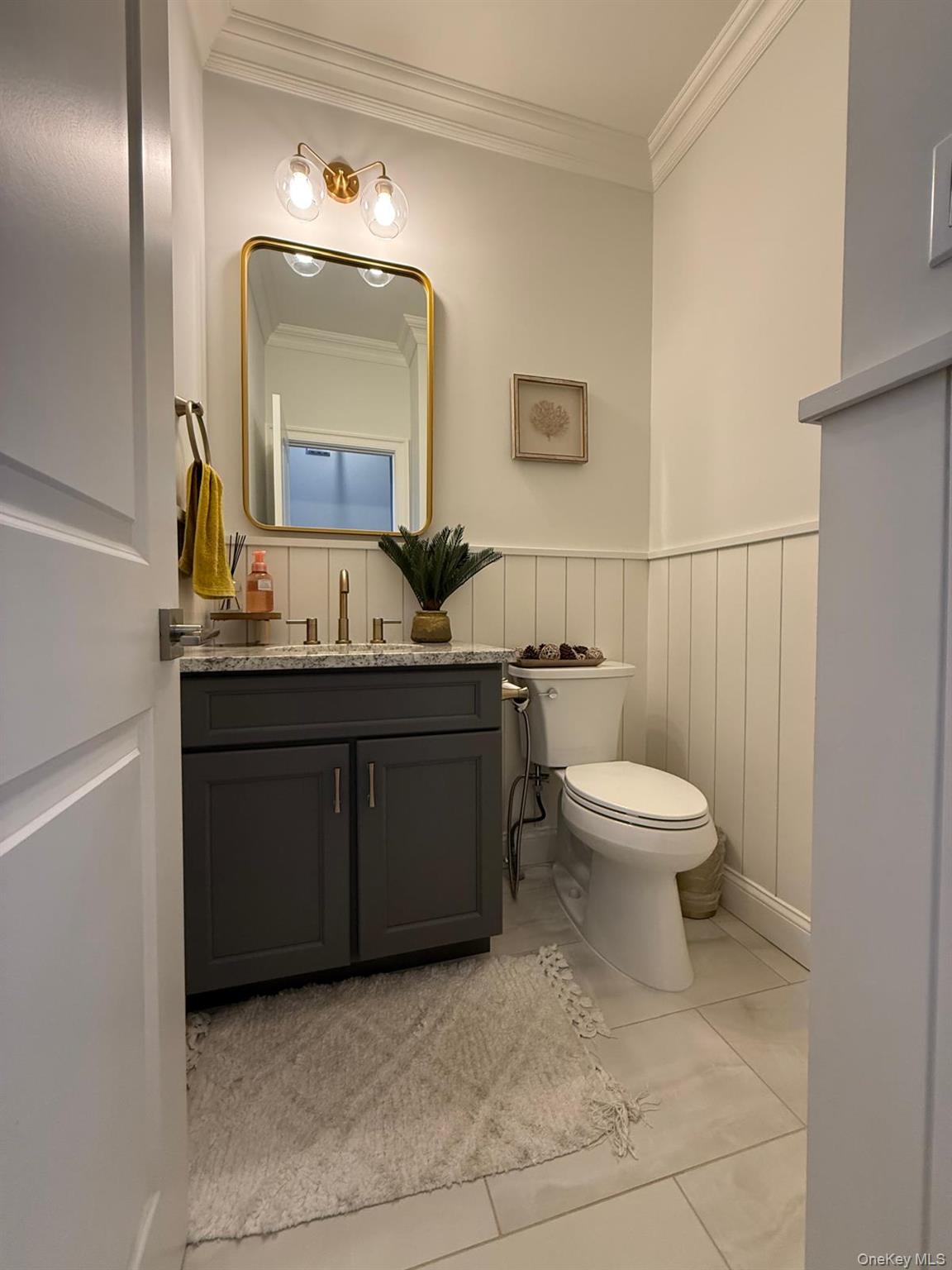 116 Winifred Drive Merrick, NY 11566 - Photo 7 of 40 a bathroom with a toilet sink and mirror