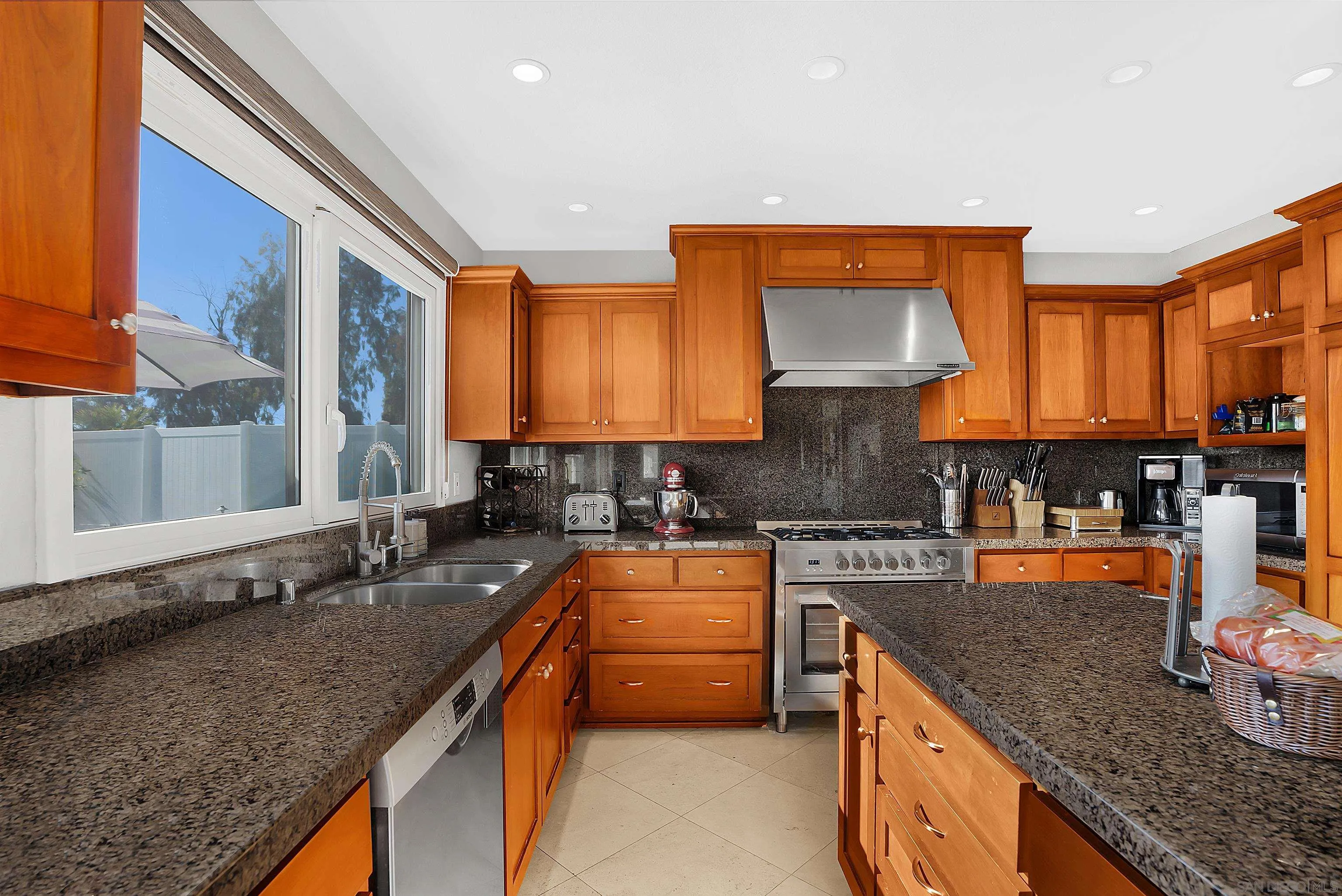 2653 Sausalito Avenue Carlsbad, CA 92010 - Photo 3 of 30 a kitchen with stainless steel appliances granite countertop a sink stove and cabinets