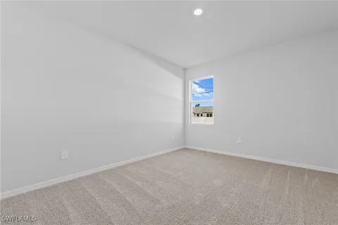 a bedroom with bed and a potted plant