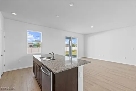 a kitchen with stainless steel appliances a refrigerator sink and microwave