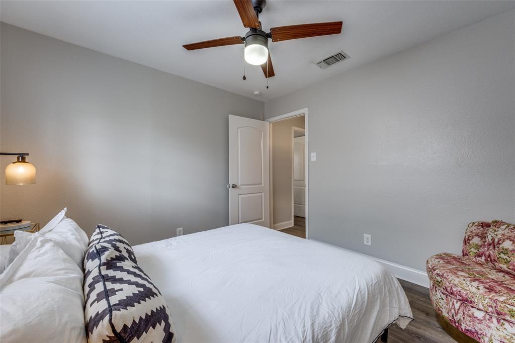 1222-1224 West Hunt Street, Unit 1222 Sherman, TX 75092 - Photo 13 of 23 a bedroom with bed and a chandelier