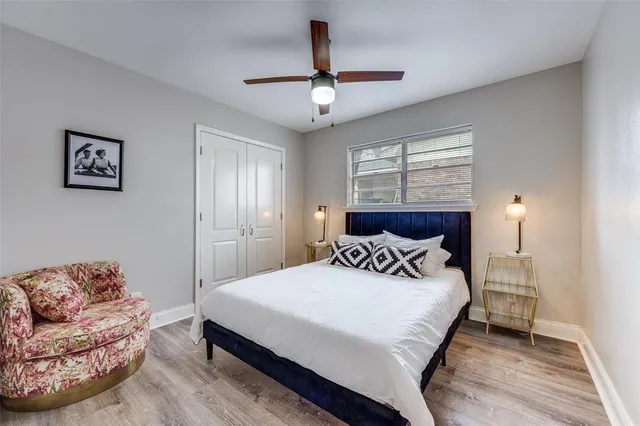 a bedroom with a bed couch and window