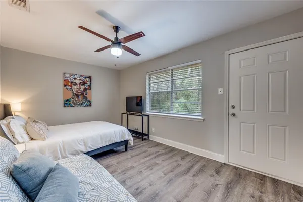 a bedroom with a large bed and a window