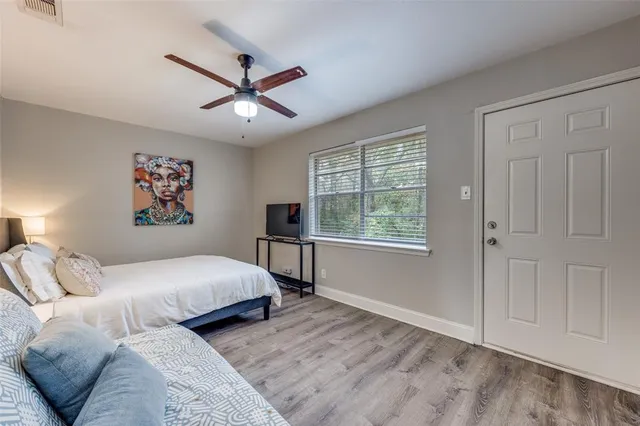 a bedroom with a large bed and a window